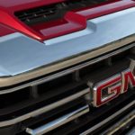 A close up of the GMC logo is shown on a 2020 GMC truck's chrome grille.
