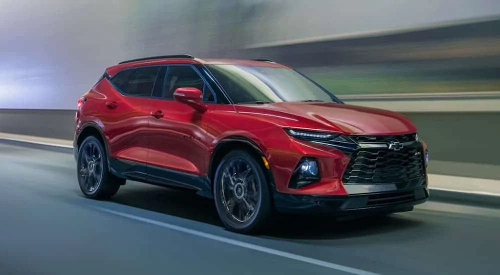 A red 2020 Chevy Blazer is driving through a dark lit tunnel.