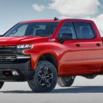 A red 2020 Chevy Silverado Trailboss, which wins when comparing the 2020 Chevy Silverado vs 2020 Ford F-150, is parked on a flat salt land.