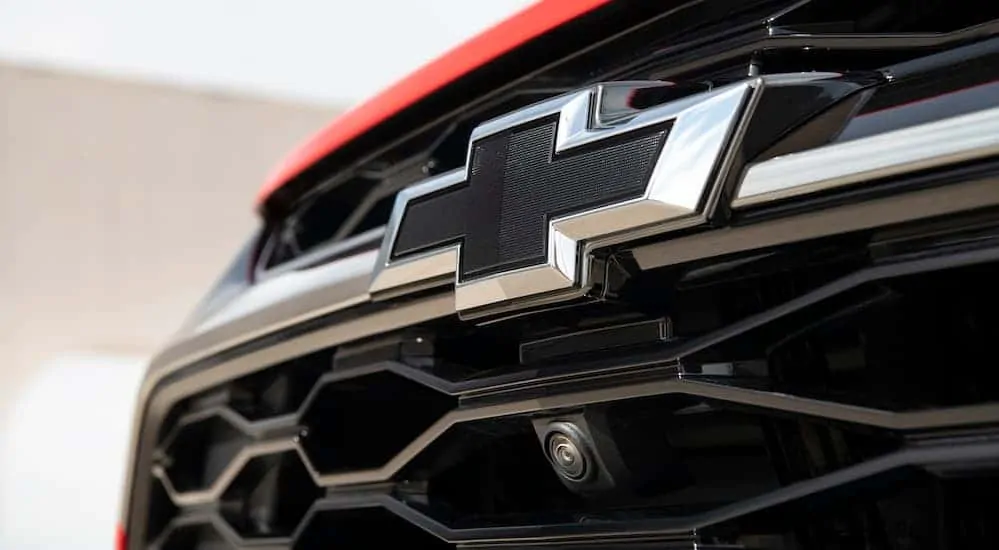A close up of a black Chevy logo is shown.