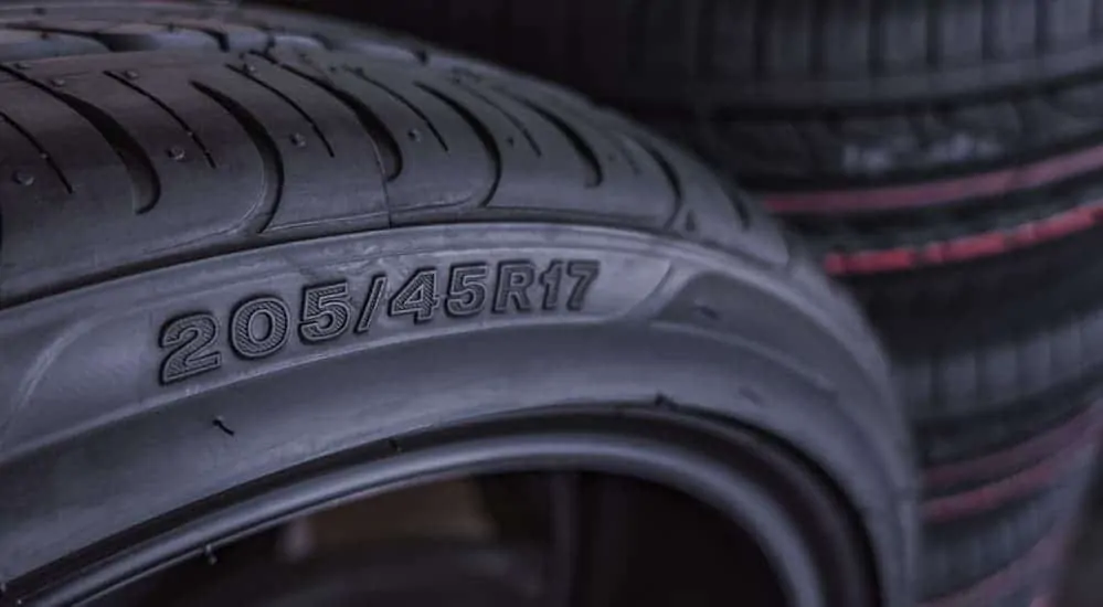 The measurements of a discount tire is shown on a tire.