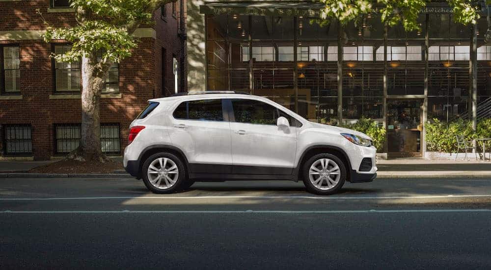 A white 2020 Chevy Trax, which wins when comparing the 2020 Chevy Trax vs 2020 Honda HR-V, is parked on a city street.