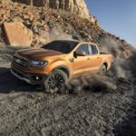 A gold colored 2020 Ford Ranger, which wins when comparing the 2020 Ford Ranger vs 2020 Toyota Tacoma, is off-roading in the desert.