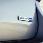 The 2020 Ford Explorer Ecoboost badge is shown in closeup on a silver Explorer.