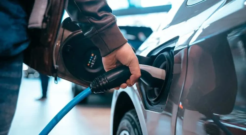 A person is charging an electric vehicle.