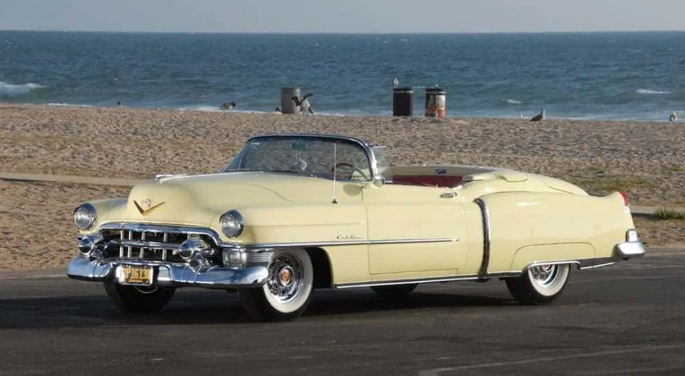 A yellow 1953 Cadillac Eldorado convertible at a beach