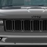 A closeup is shown of the grille on a gray 2020 Jeep Grand Cherokee High Altitude.