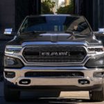 A grey 2020 Ram 1500 is facing forward while parked in an ally.