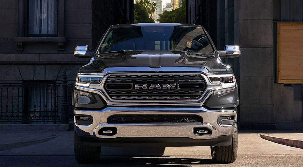 A grey 2020 Ram 1500 is facing forward while parked in an ally.
