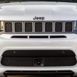 The grille of a white 2020 Jeep Grand Cherokee is shown, which is popular among Jeep models.