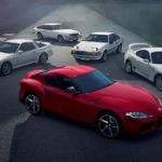 A red 2020 Toyota Supra is surround by white older models after leaving a Toyota dealer near me.