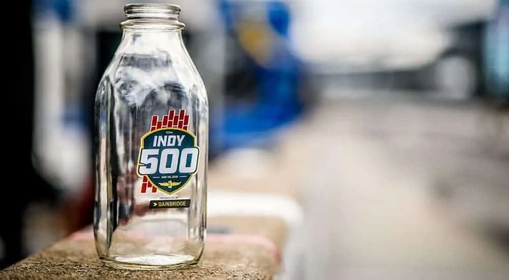 An empty milk glass is sitting on a railing, getting ready for the 104th Indianapolis 500.