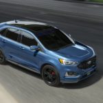 A blue 2020 Ford Edge ST is shown from a above on a highway.