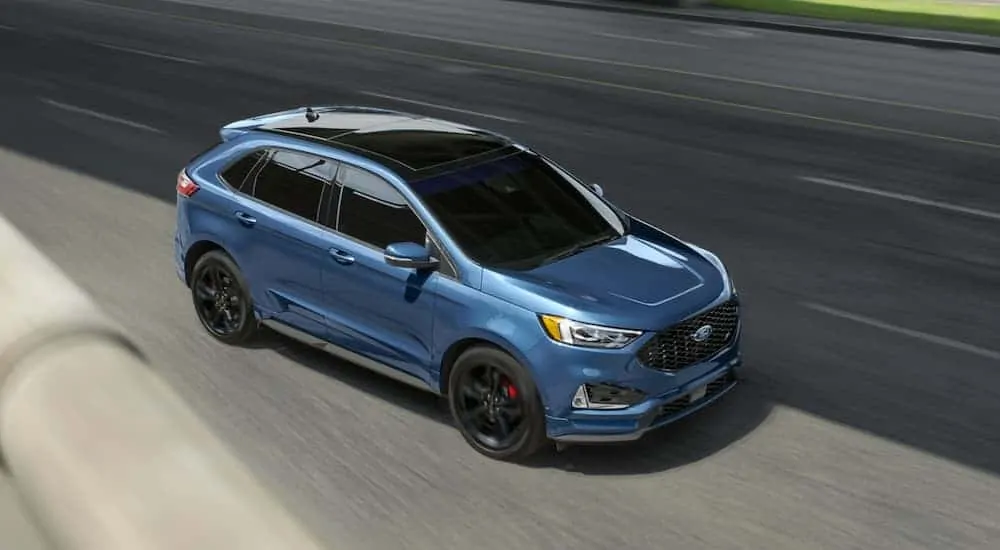 A blue 2020 Ford Edge ST is shown from a above on a highway.