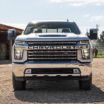 A white 2020 Chevy Silverado 2500HD Custom Z71 is shown from the front and is parked on a ranch.