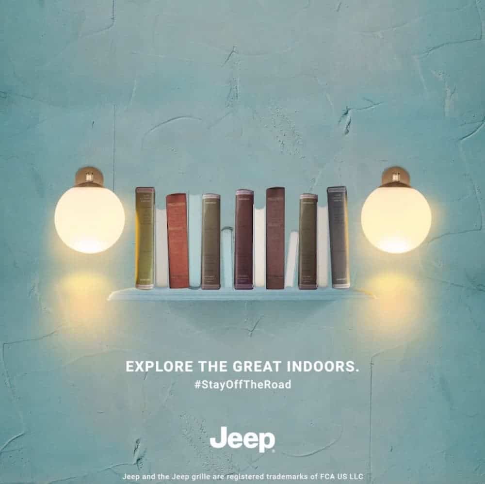 A bookshelf and lights are on a light blue wall and resemble a Jeep grille, overlaying text reads "Explore the great indoors. #stayofftheroad Jeep".