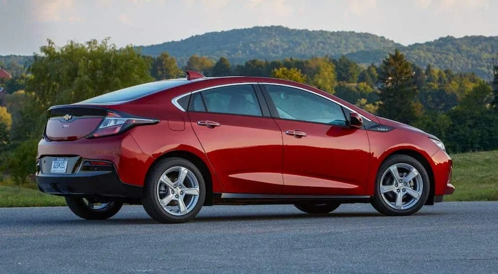 If you're looking for used cars for sale you should check out cars like this red 2019 Chevy Volt that is parked in an open lot.