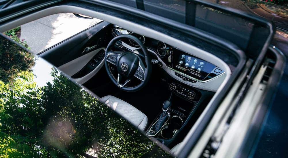 The open sunroof is shown from above on a blue 2020 Buick Encore GX.