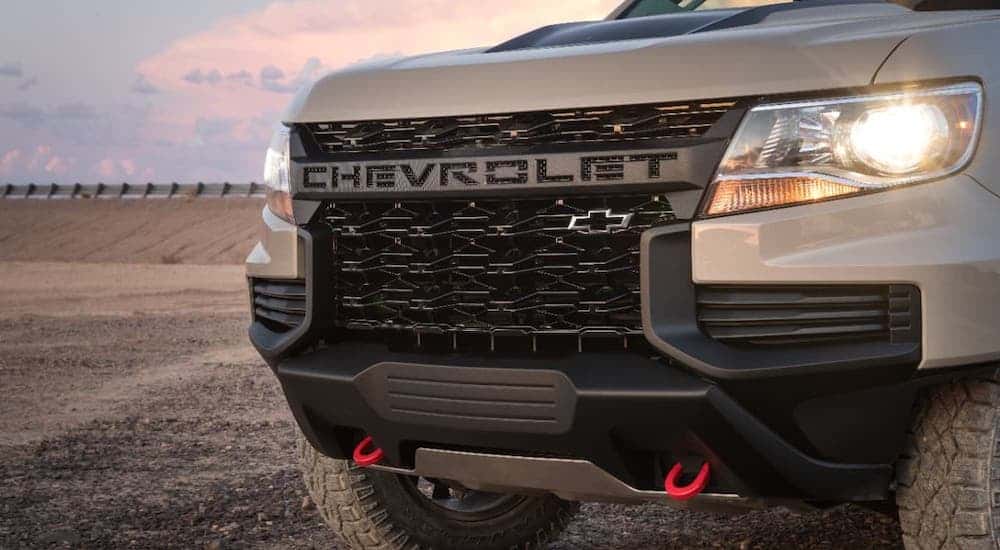 A closeup is showing the grille of a tan 2021 Chevy Colorado ZR2.