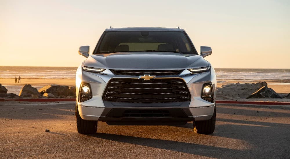 A silver 2020 Chevy Blazer is shown from the front at a beach at sunset.