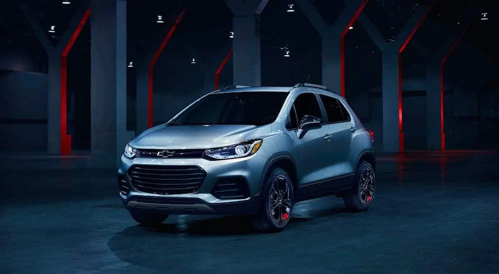 A silver 2020 Chevy Trax is parked in an empty warehouse.