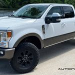 A white 2020 Ford F-250 Super Duty Tremor is shown at an angle in front of a river.