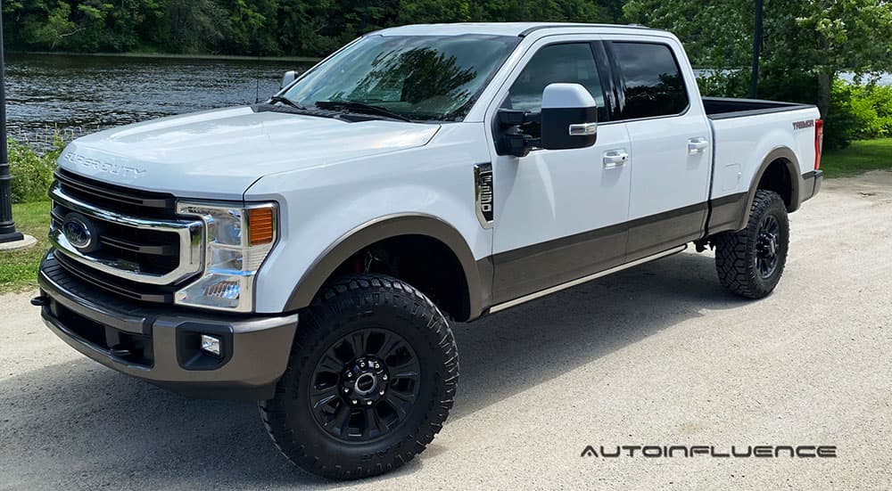 A white 2020 Ford F-250 Super Duty Tremor is shown at an angle in front of a river.
