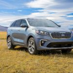 A grey 2020 Kia Sorento is parked in a field with mountains in the distance after winning the 2020 Kia Sorento vs 2020 Honda Pilot comparison.