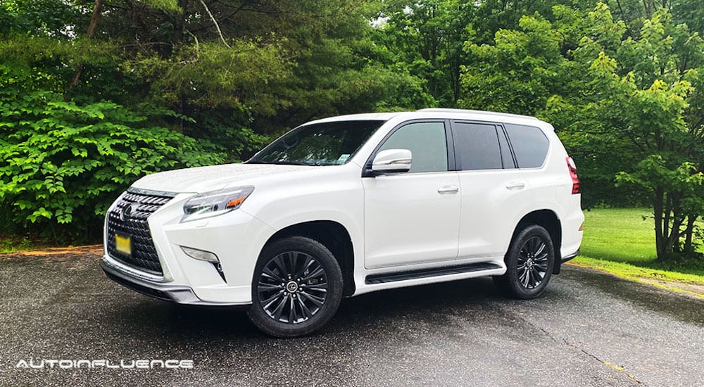 A white 2020 Lexus GX 460 is parked in front of trees.