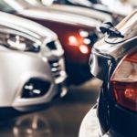 Several used cars for sale are in a dealership.