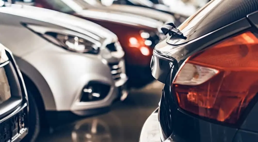 Several used cars for sale are in a dealership.