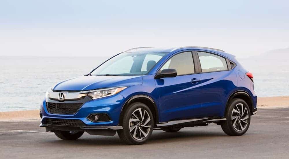 A blue 2020 Honda HR-V is parked at a beach.