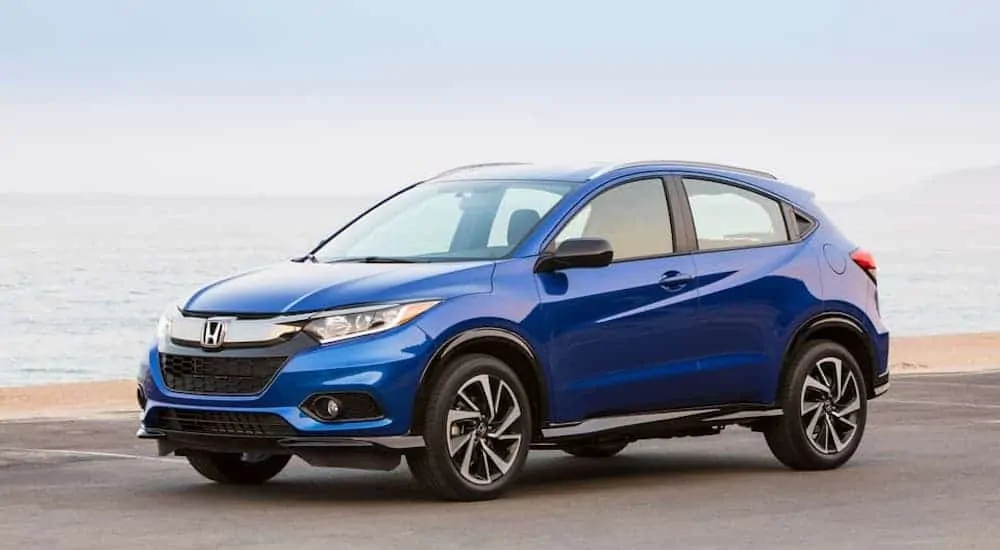 A blue 2020 Honda HR-V is parked at a beach.