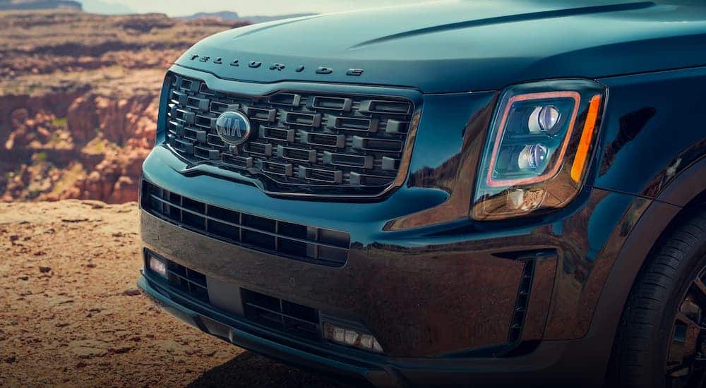 A closeup shows the grille on a green 2020 Kia Telluride.