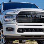 A closeup shows a white 2020 Ram 2500 from the front.