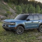 A blue 2021 Ford Bronco Sport is parked in the mountains.