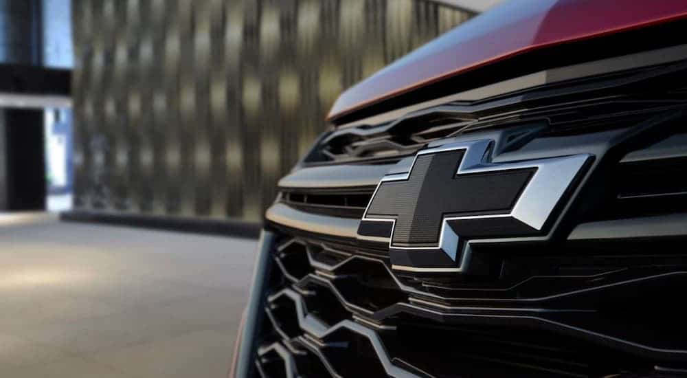 A closeup shows the blacked out Chevrolet logo on a 2022 Chevy Equinox.