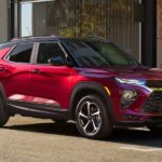 A red 2021 Chevy Trailblazer, one of the new Chevy SUVs, is parked on a city street.