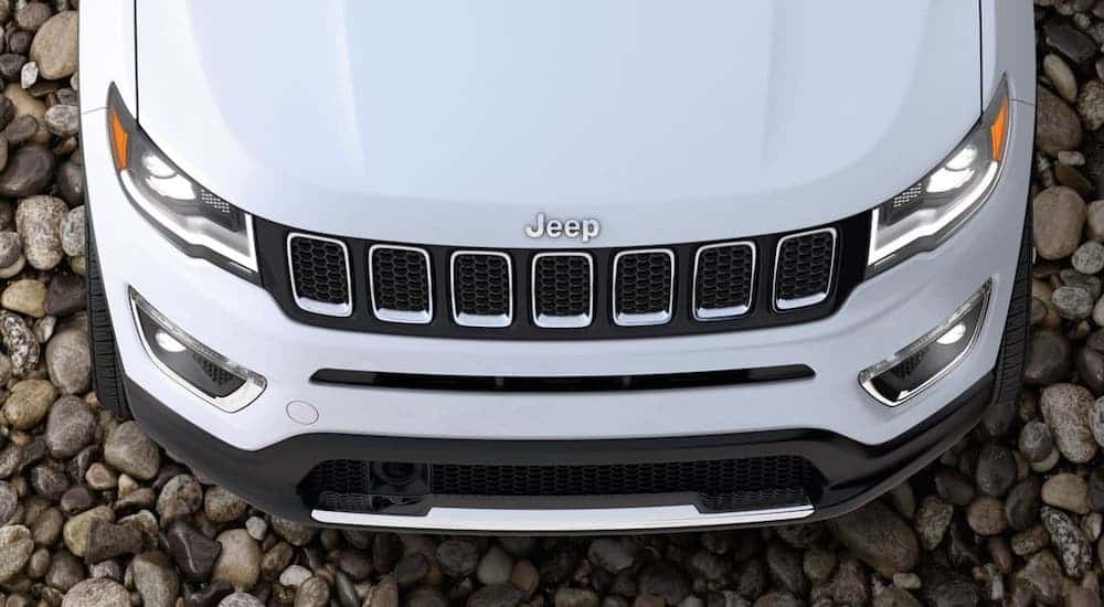 The hood of a white 2020 Jeep Compass is shown from above.