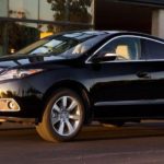 A black 2010 Acura ZDX is shown parked on a city street.