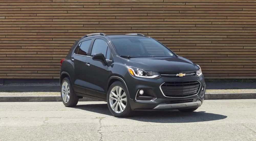 A grey 2020 Chevy Trax is parked in front of a wood wall after winning the 2020 Chevy Trax vs 2020 Jeep Renegade comparison.