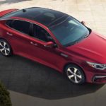A red 2020 Kia Optima is shown from above on tan tiles after winning the 2020 Kia Optima vs 2020 Toyota Camry comparison.