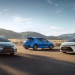 Three versions of the 2021 Toyota Corolla are parked in a desert with distant mountains.