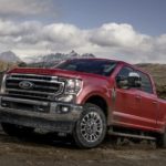 A red 2020 Ford Superduty F-250 Lariat is parked in a quarry.