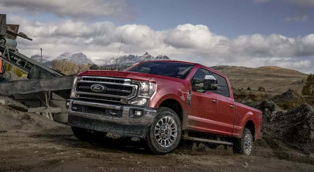 A red 2020 Ford Superduty F-250 Lariat is parked in a quarry.