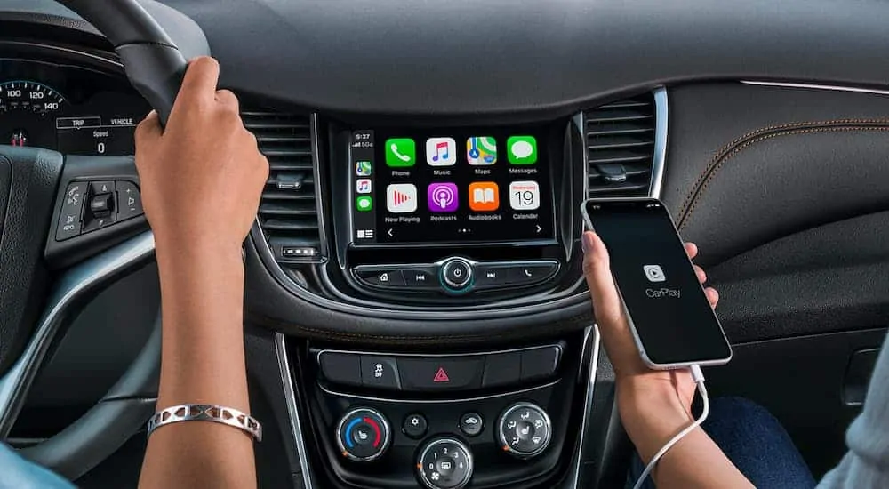 The interior view of a 2021 Chevorlet Trax is showing the infotainment screen with a phone connected and car play running.