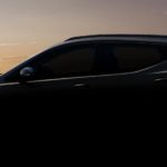 A dark 2022 Chevy Bolt EUV is in front of a sunset.