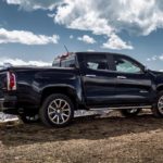 A dark blue 2020 GMC Canyon Denali is parked in the mountains.