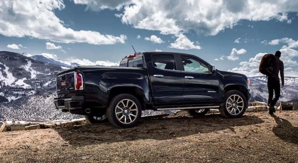 A dark blue 2020 GMC Canyon Denali is parked in the mountains.