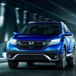 A blue 2020 Honda CR-V is driving through a bridge after winning the 2020 Honda CR-V vs 2020 Toyota RAV4 comparison.